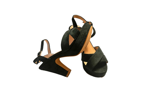 Green high-heel sandals with crisscross straps and ankle buckle on white background