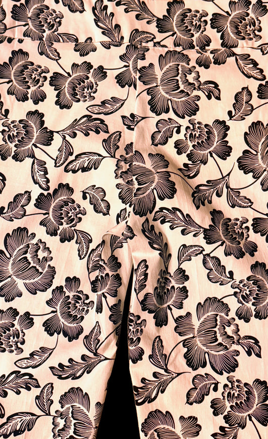 Close up of petite printed pants with black floral pattern on light fabric