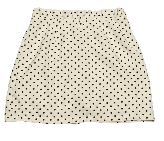 White polka dot skirt with black spots, elastic waistband, isolated on black background