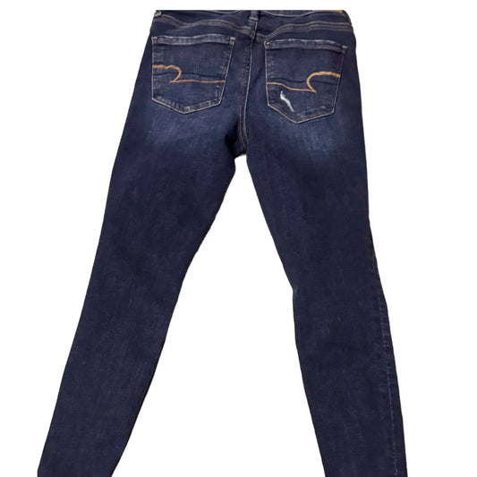 Back view of dark blue skinny jeans with contrast stitching on rear pockets