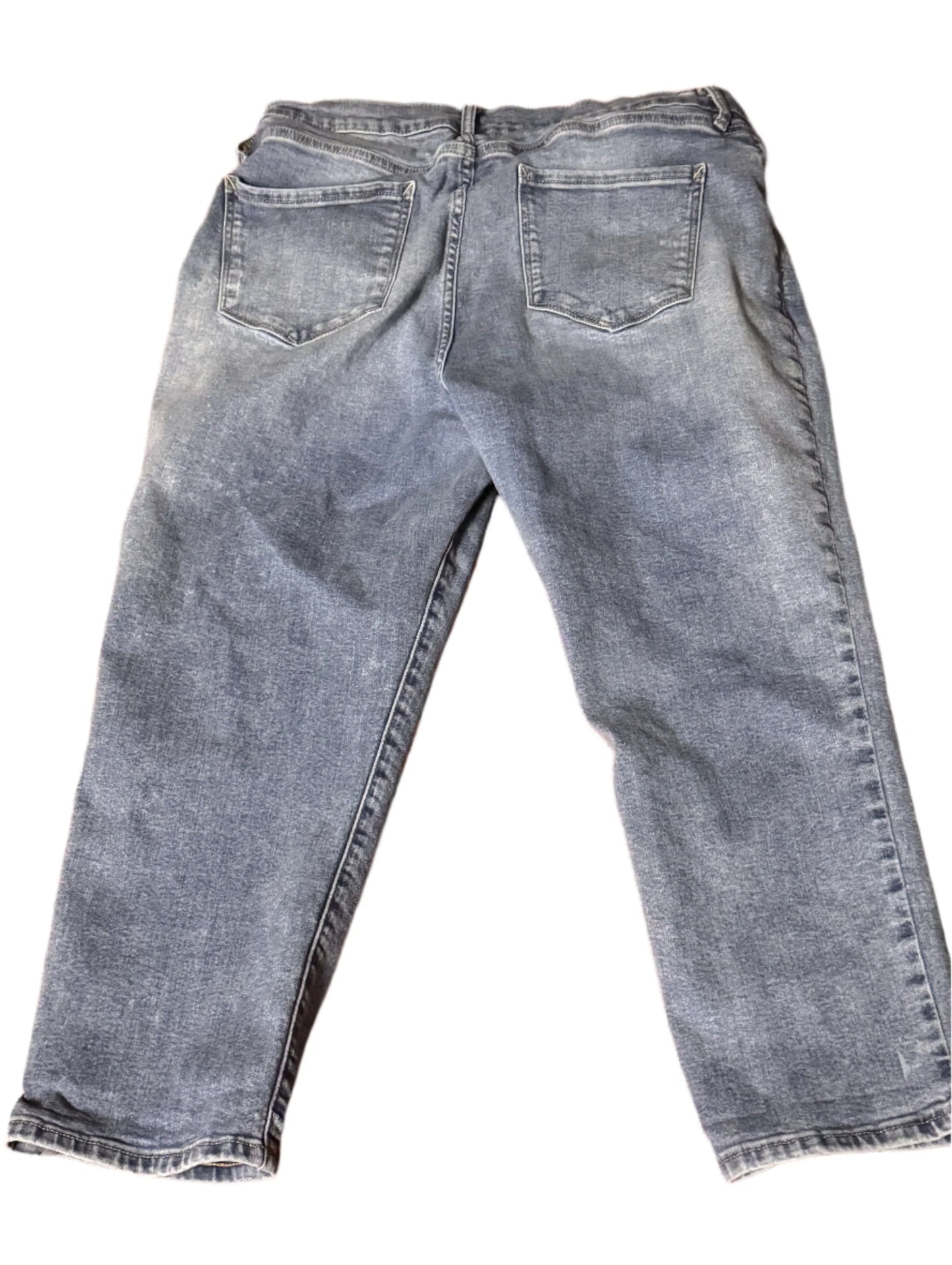 Back view of light wash denim jeans with straight leg and two rear pockets on white background.