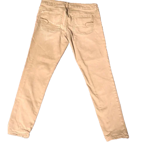 back view of beige American Eagle denim pants with stitched pockets on black background