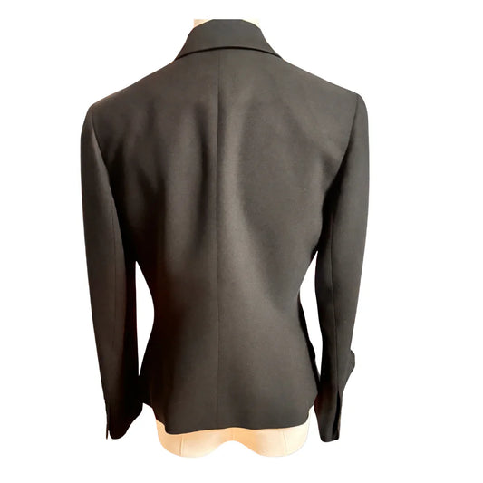 Back view of black blazer jacket on mannequin, tailored fit, white background