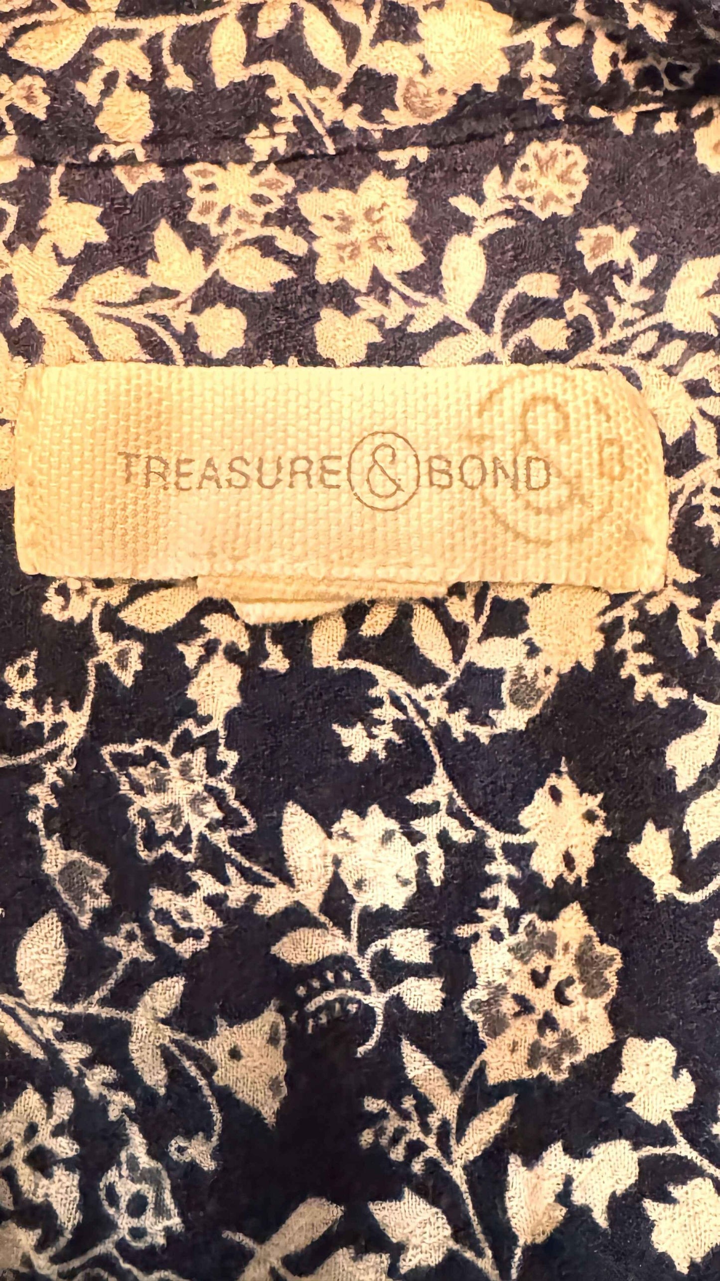 Treasure & Bond brand tag on blue blouse with white floral print pattern