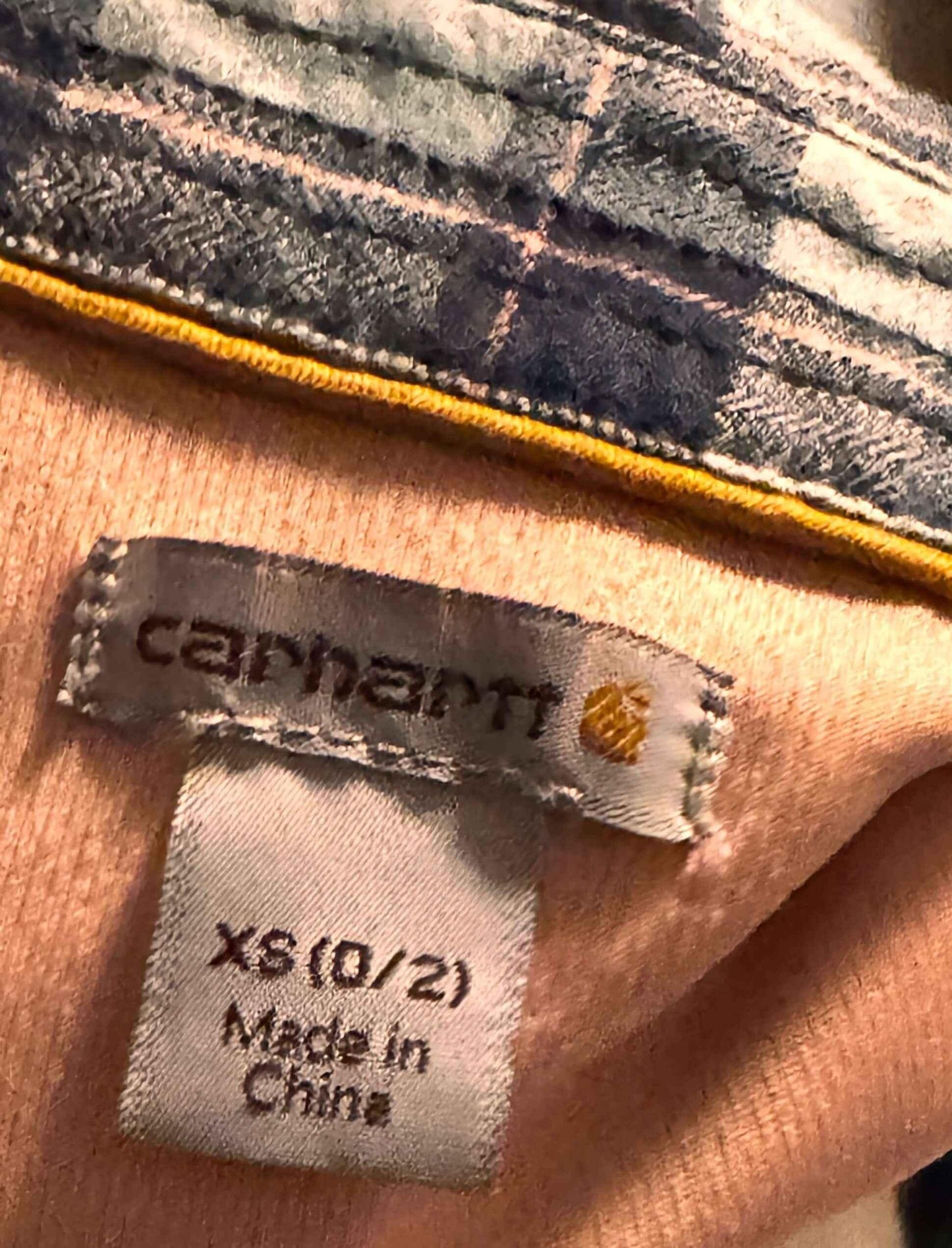 Carhartt flannel shirt collar with XS size and Made in China label tags