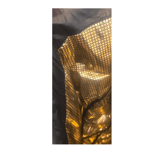 Closeup of Columbia jacket gold thermal reflective lining with honeycomb pattern