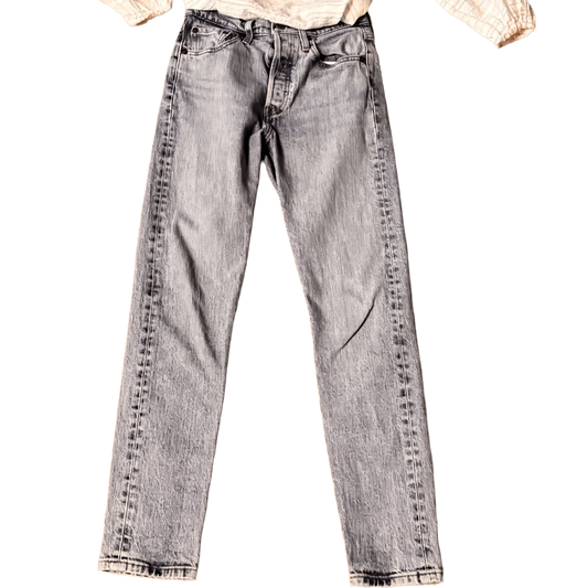 Front of classic light wash Levi's jeans with button fly on black background