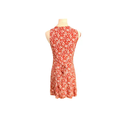 Red sleeveless dress with white floral print shown on mannequin, back view