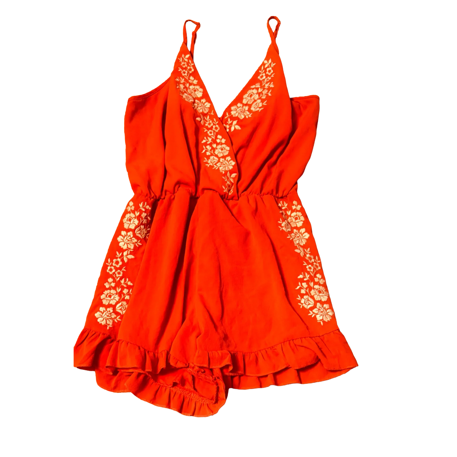 Red romper with white floral embroidery, ruffled hem, and spaghetti straps on black background