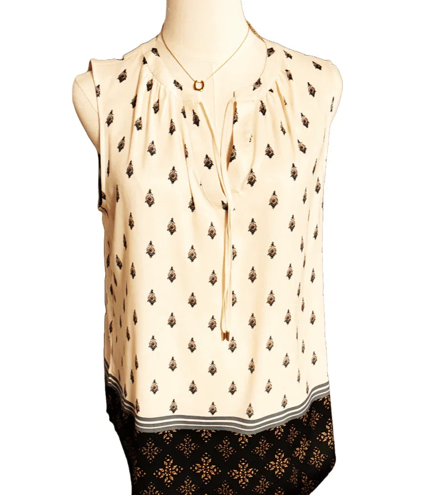 Ann Taylor sleeveless patterned blouse with black and beige geometric print on mannequin