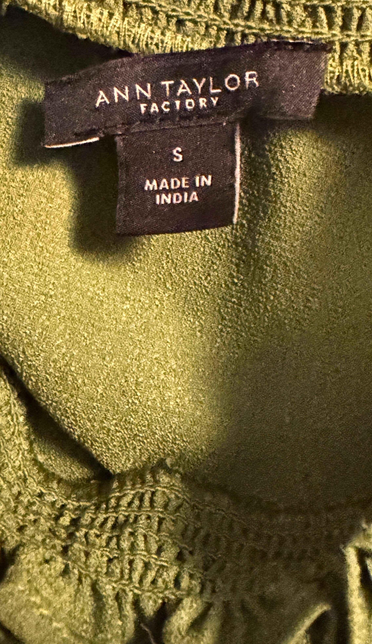 Ann Taylor Factory green blouse label, size small, made in India, close-up fabric texture