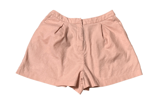 Light pink ASOS women’s high-waisted shorts with pleats, flat lay on black background