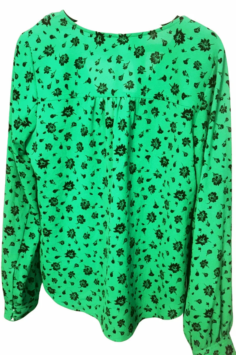 Green floral print blouse with long sleeves and black flower patterns