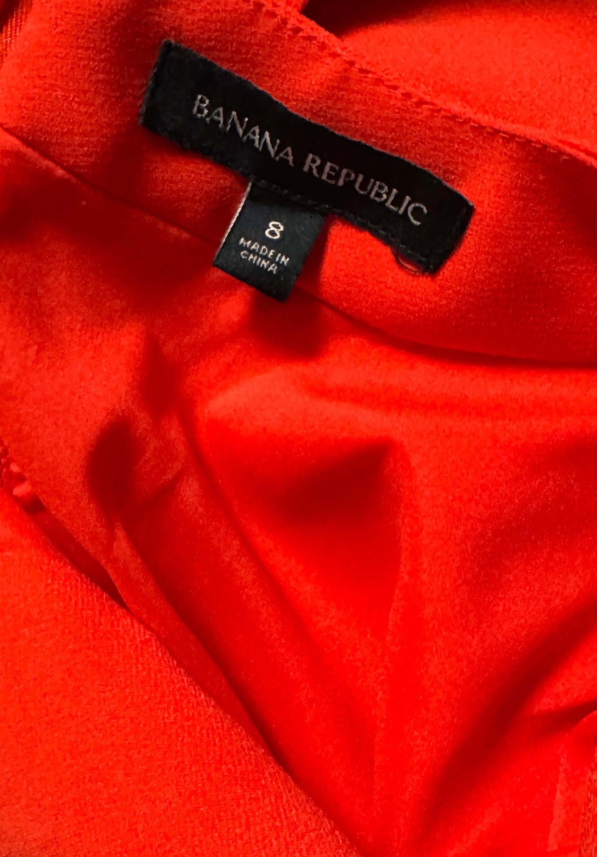 Banana Republic red dress size 8 clothing tag close-up on vibrant fabric