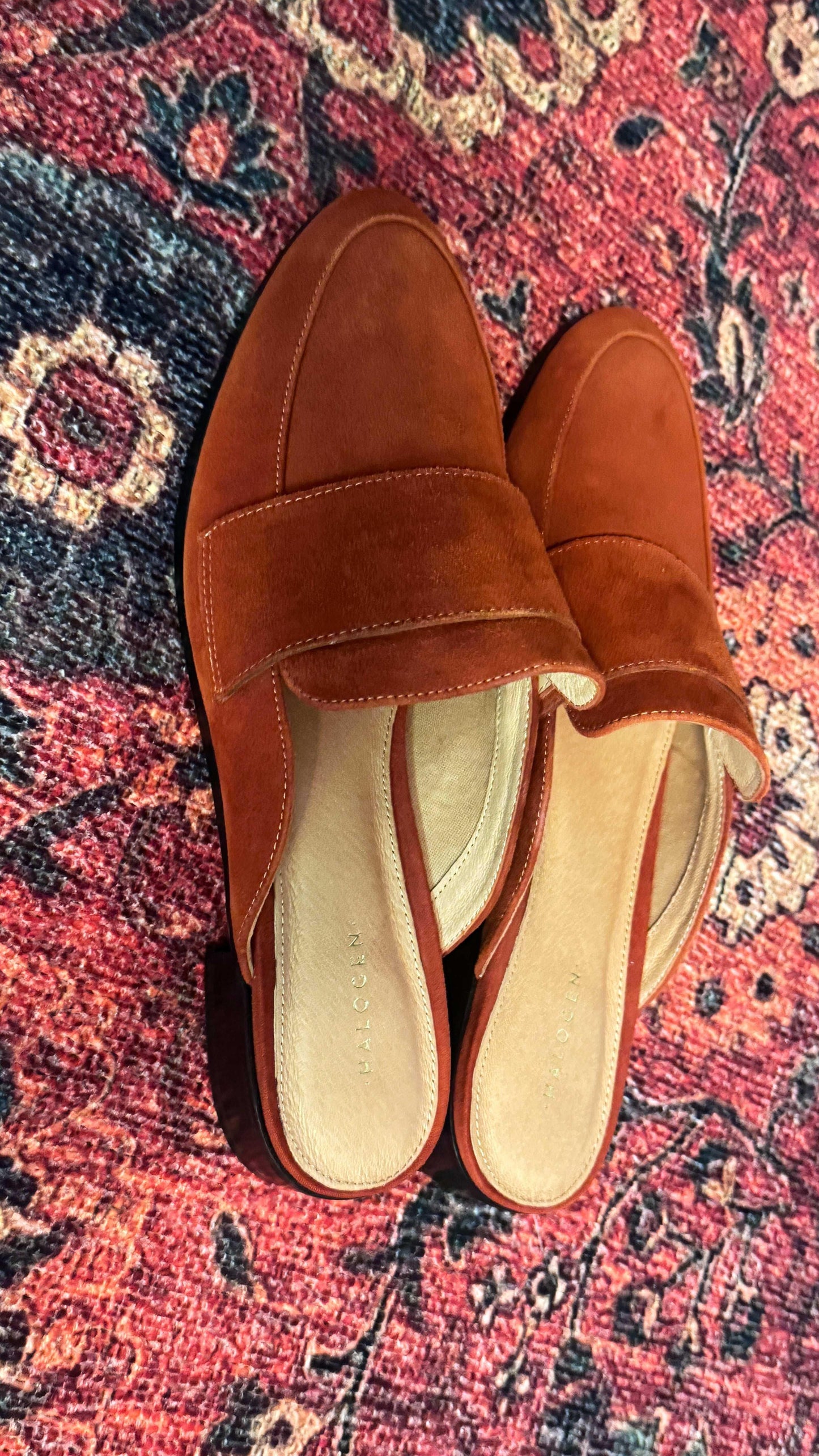 Burnt orange suede women’s mules by Halogen on a patterned red rug