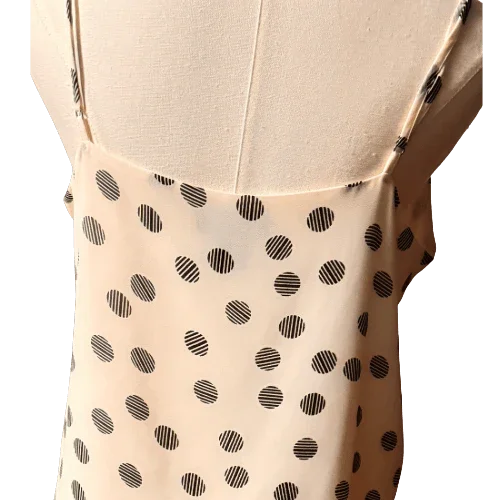 Back view of beige polka dot Cynthia Rowley women's blouse on mannequin