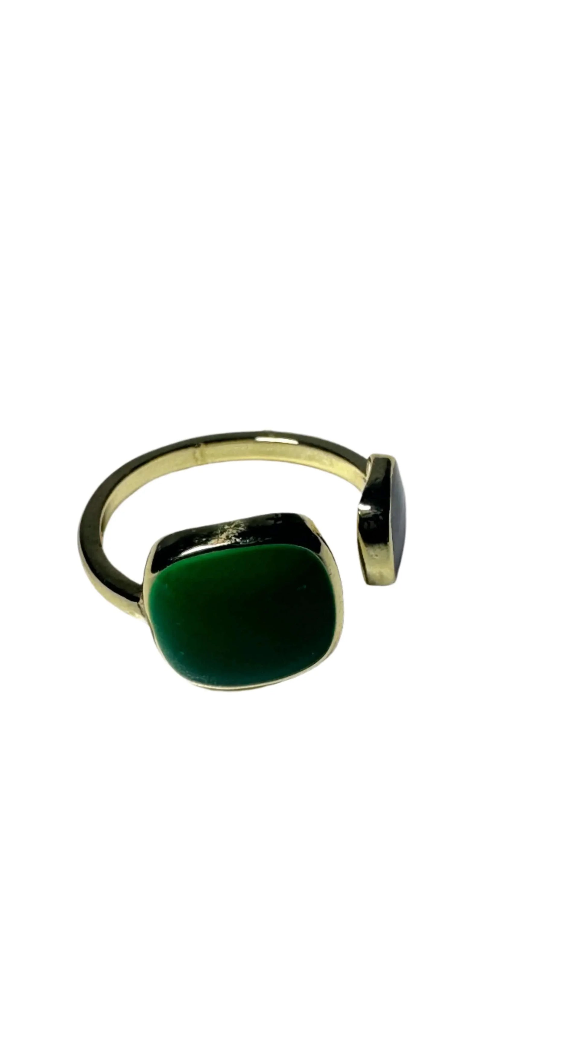 Emerald green open ring with gold band on white background