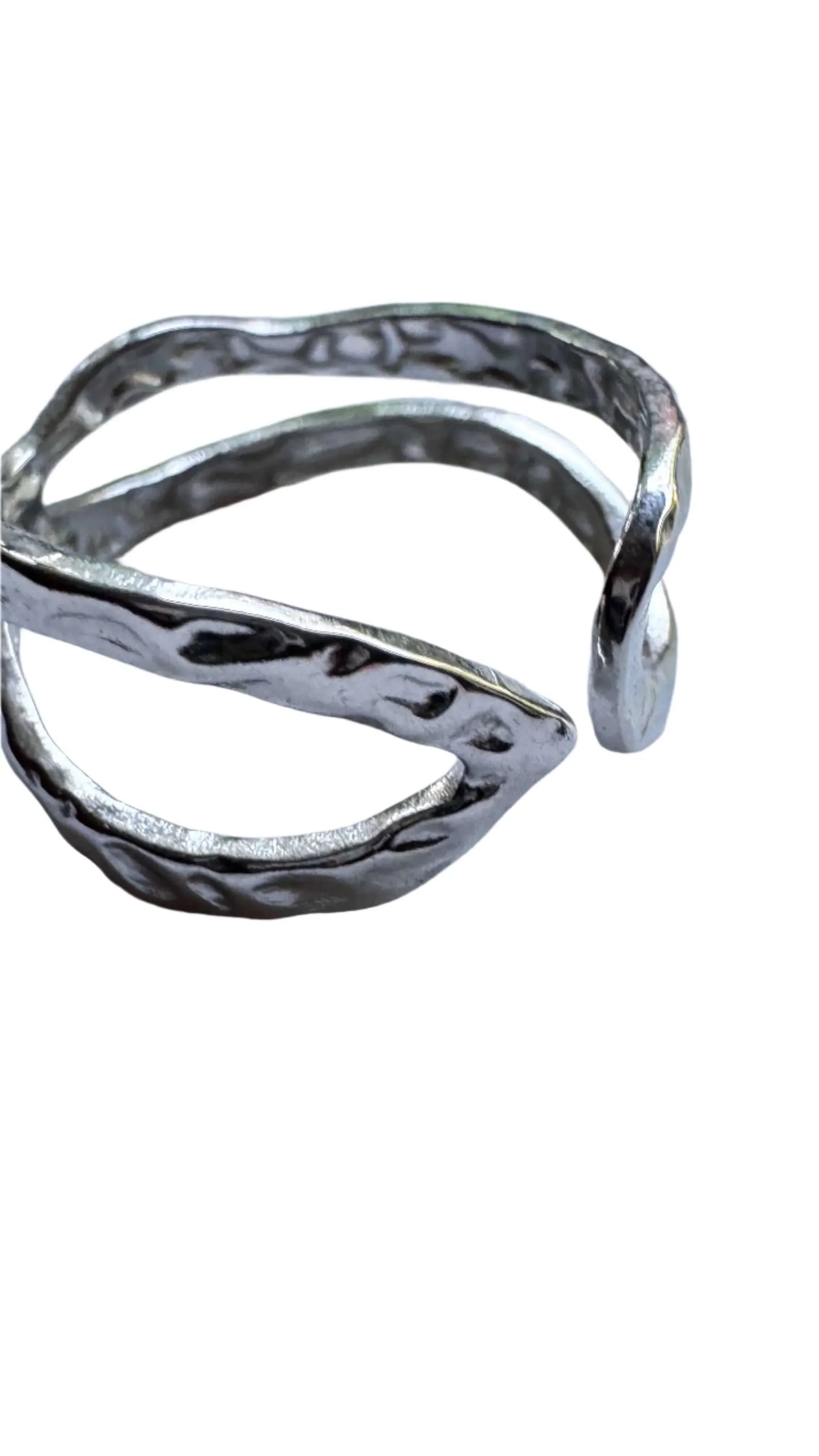 Hammered open silver ring with textured finish on white background