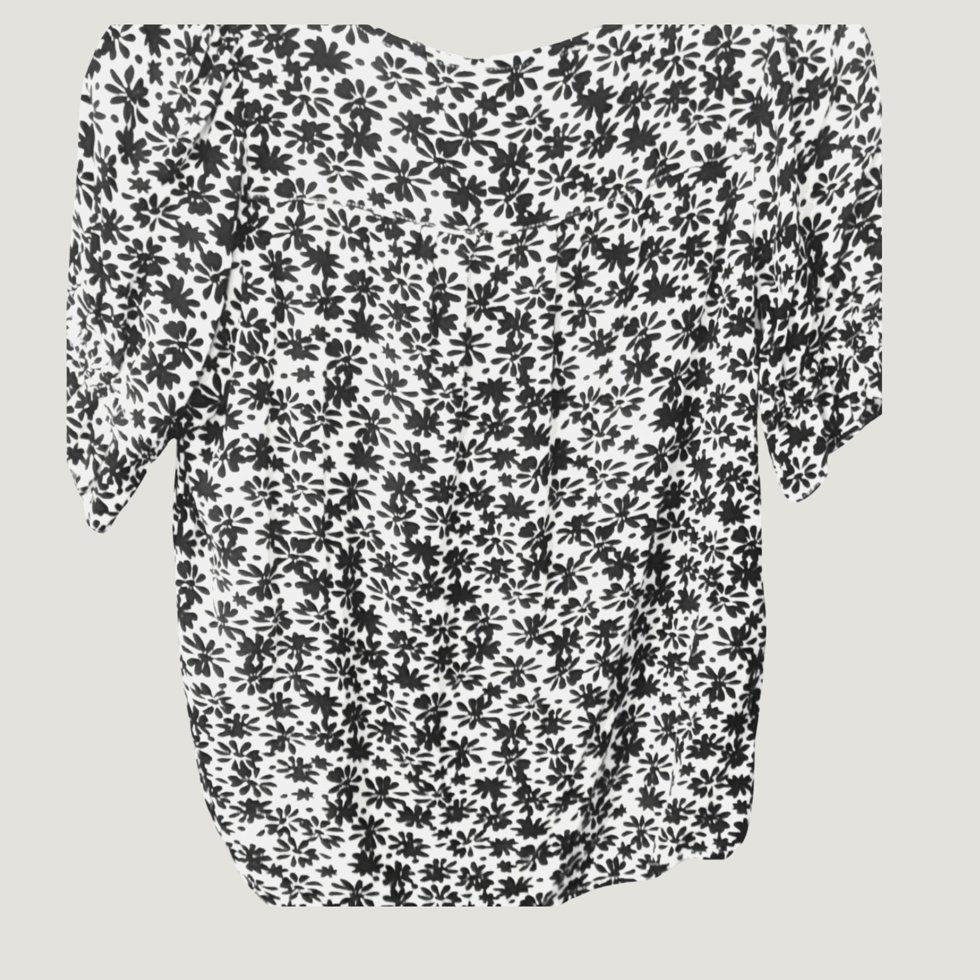White blouse with black floral print and half sleeves, back view on plain background