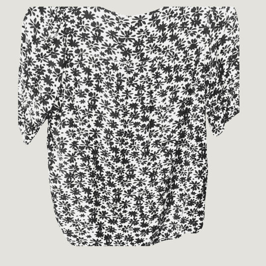 White blouse with black floral print and half sleeves, back view on plain background