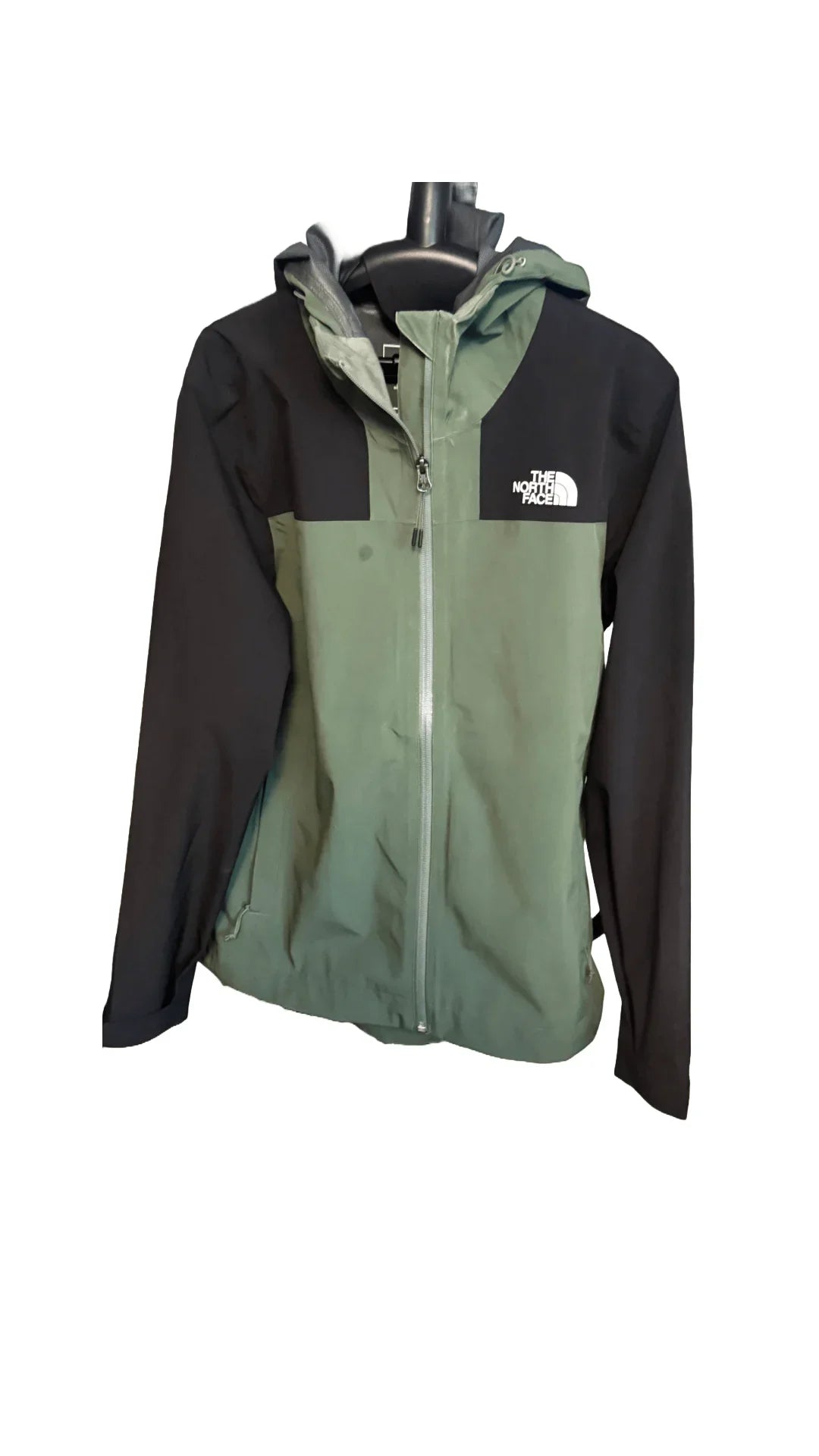 The North Face green and black hooded jacket with front zipper on a hanger