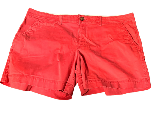 Old Navy red shorts with button closure and front pockets, isolated on black background