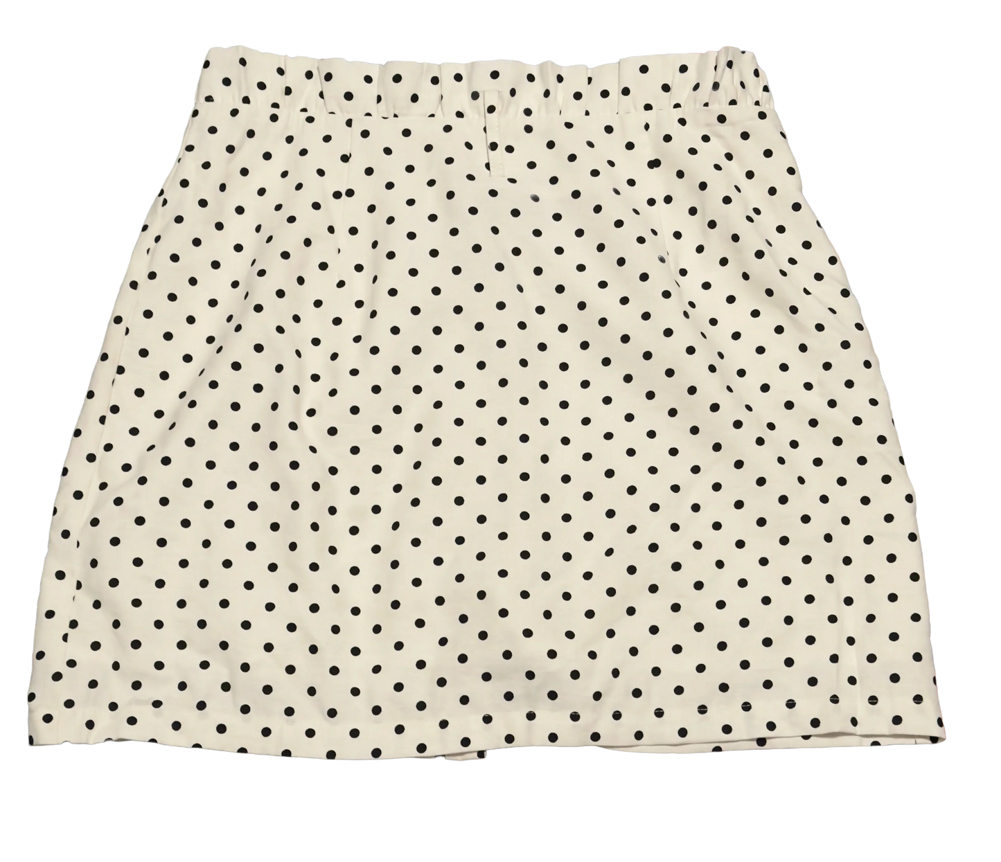 White polka dot skirt with black spots, elastic waistband, isolated on black background