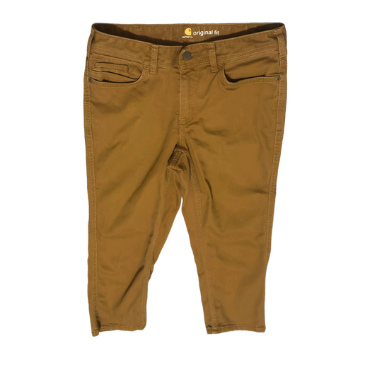 Carhartt original fit brown work pants with front pockets on black background
