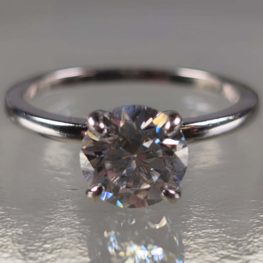Solitaire moissanite engagement ring with round brilliant stone on silver band