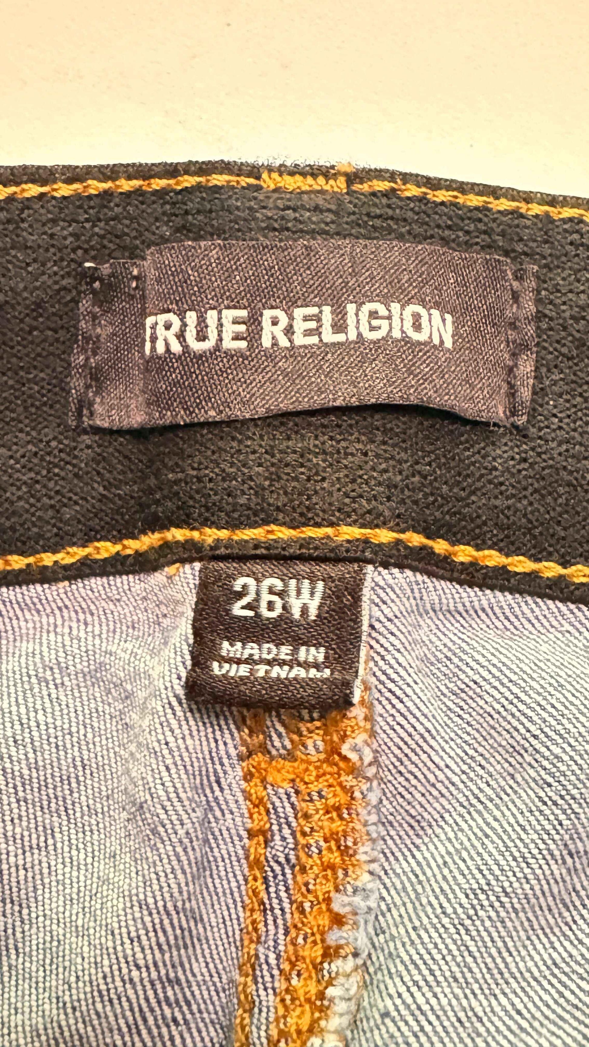 True Religion denim jean tags, size 26W, made in Vietnam with visible orange stitching