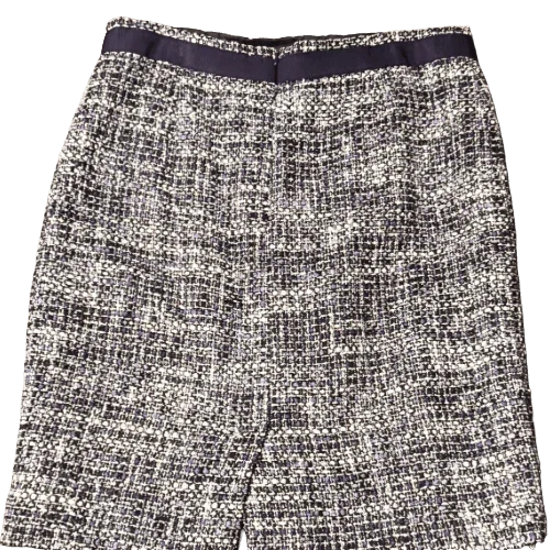 Women's black and white tweed skirt with high waist, textured fabric, and classic style