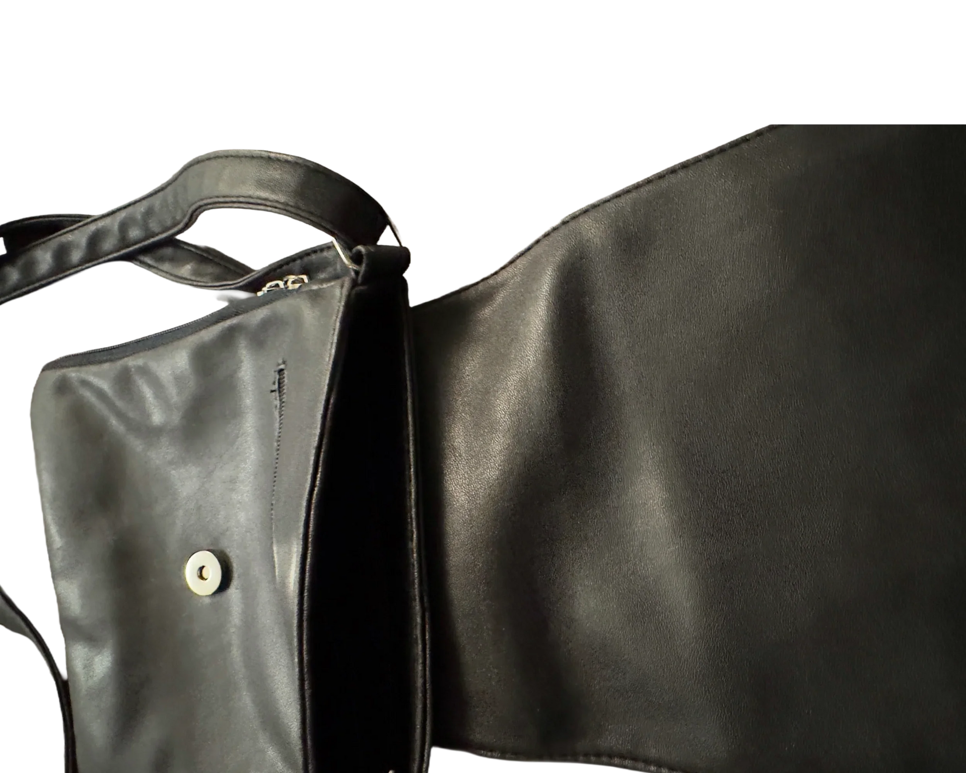 Open black leather shoulder bag with magnetic snap closure on a black background