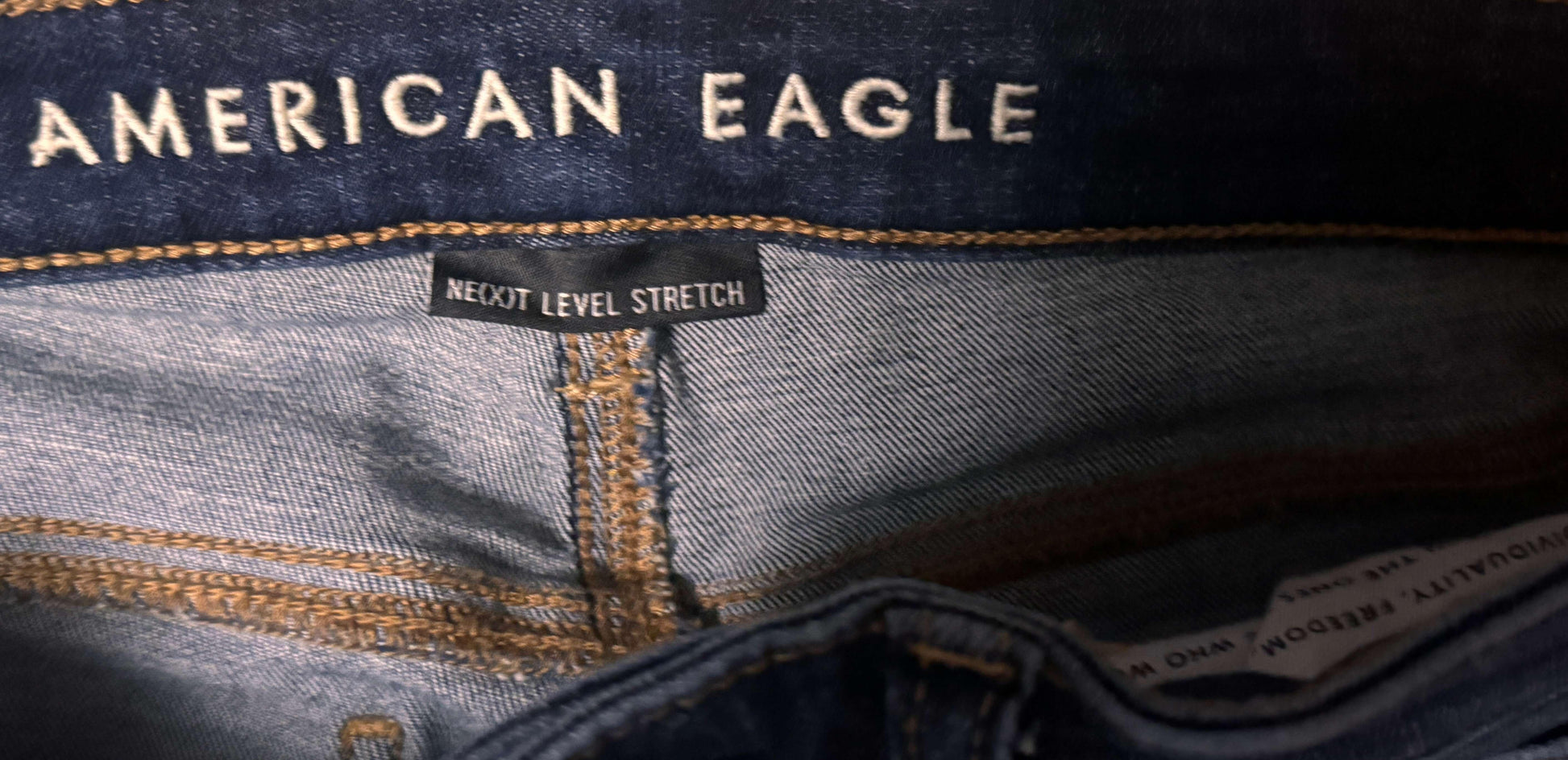 American Eagle denim jeans inside tag with Next Level Stretch label, blue stitching