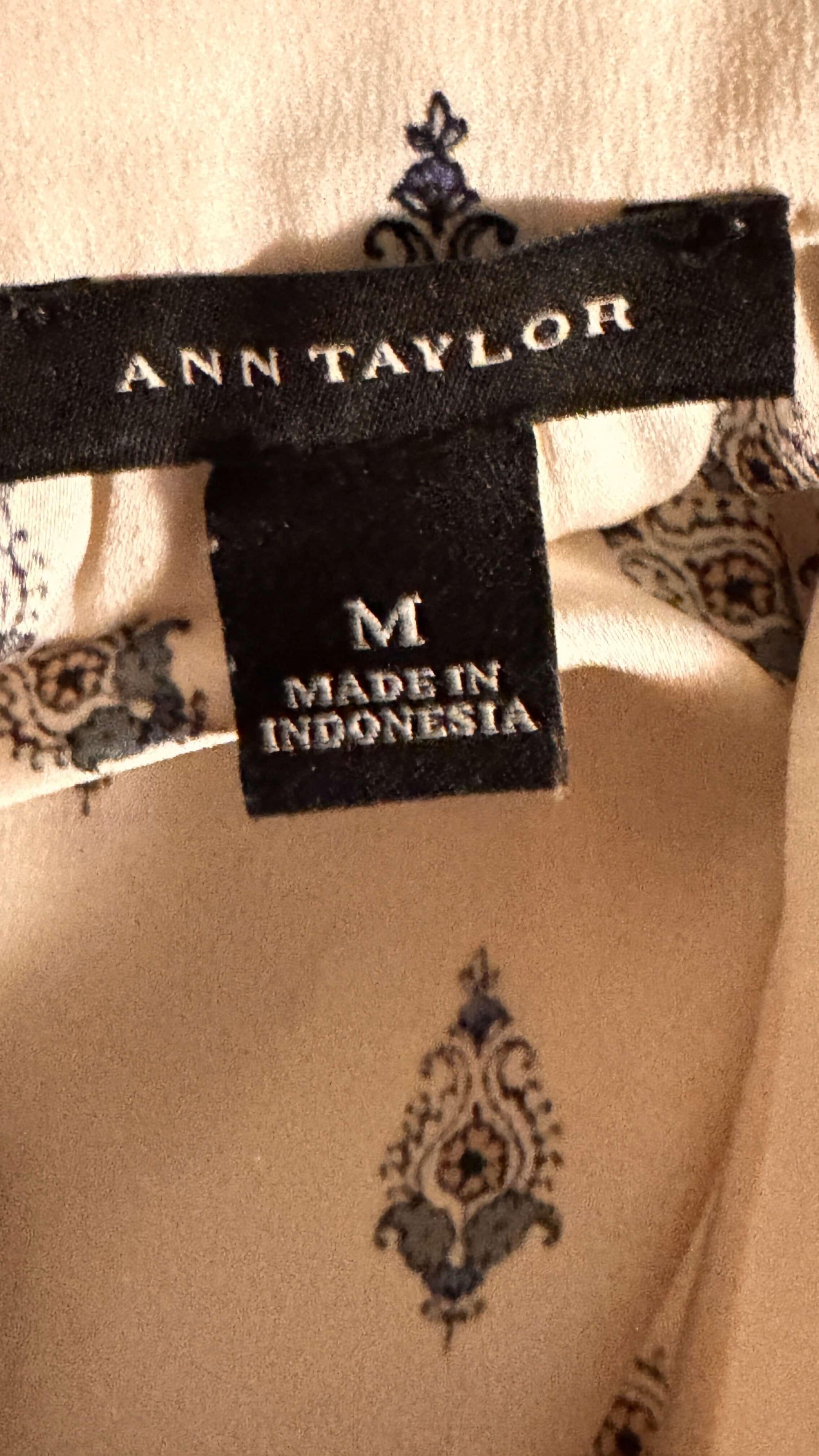 Ann Taylor clothing label, size M, made in Indonesia on cream patterned fabric