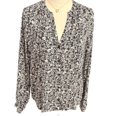 Blue and white floral blouse with long sleeves on mannequin, button-up front