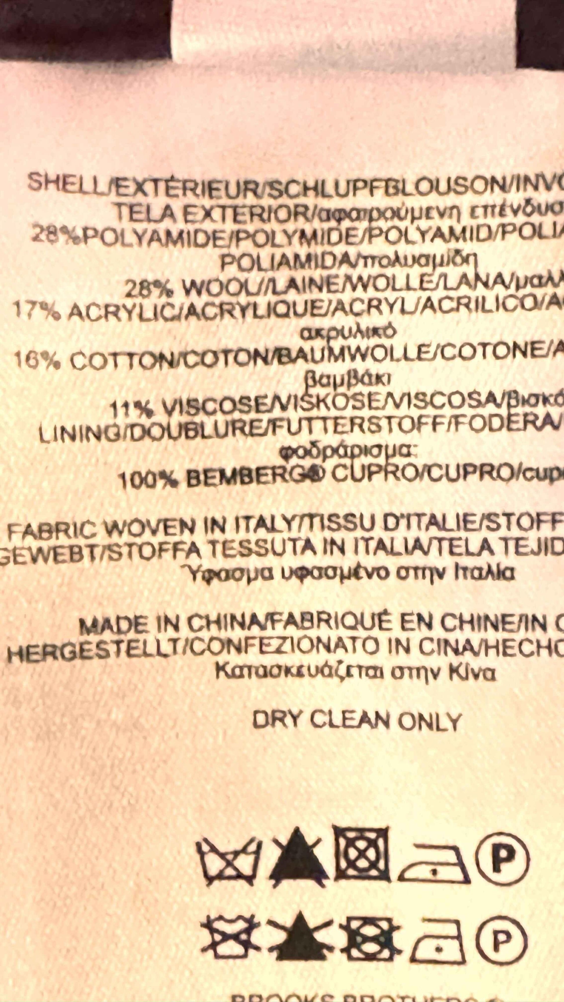 Brooks Brothers clothing tag showing fabric content, care instructions, and multi-language text.