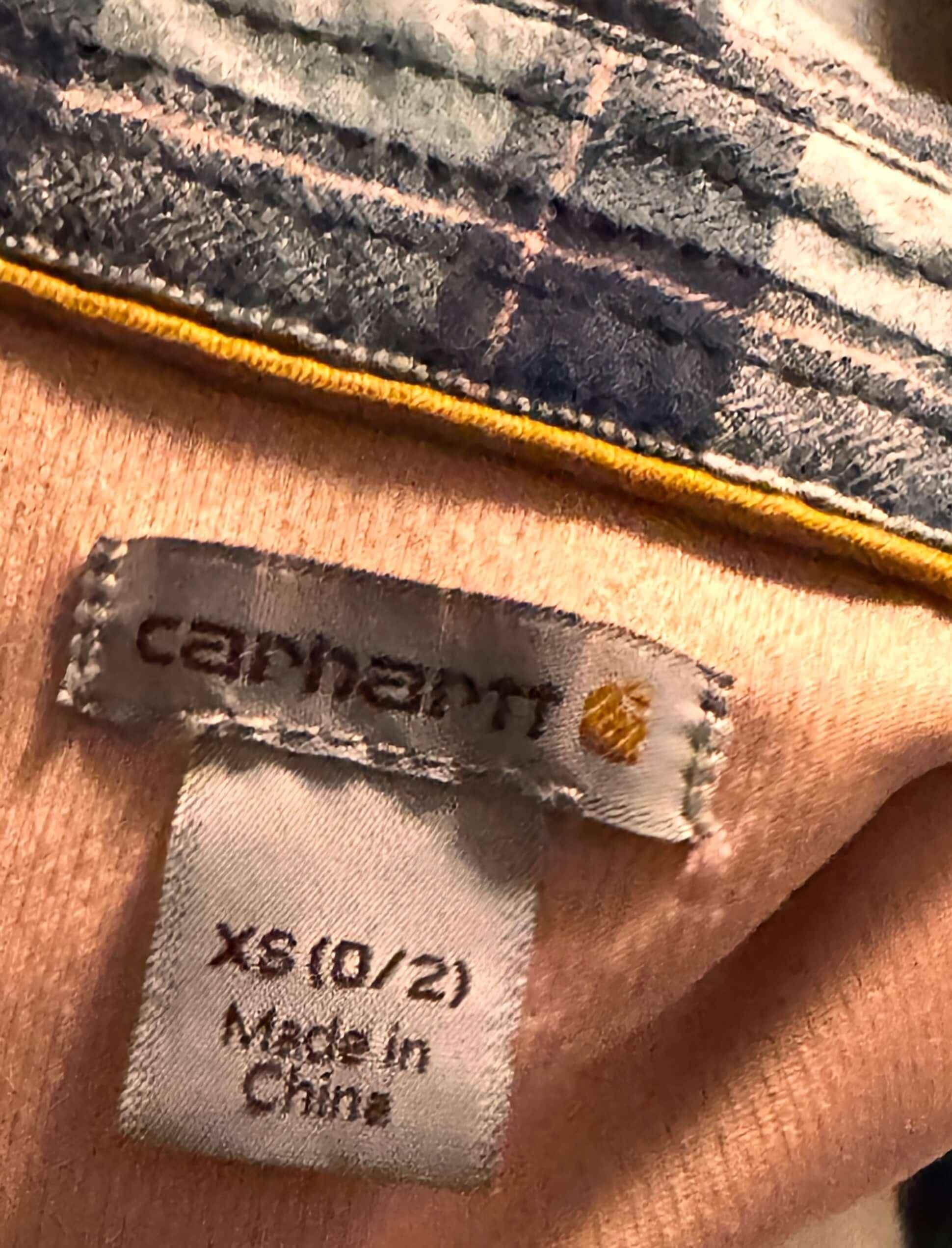 Carhartt flannel shirt collar with XS size and Made in China label tags
