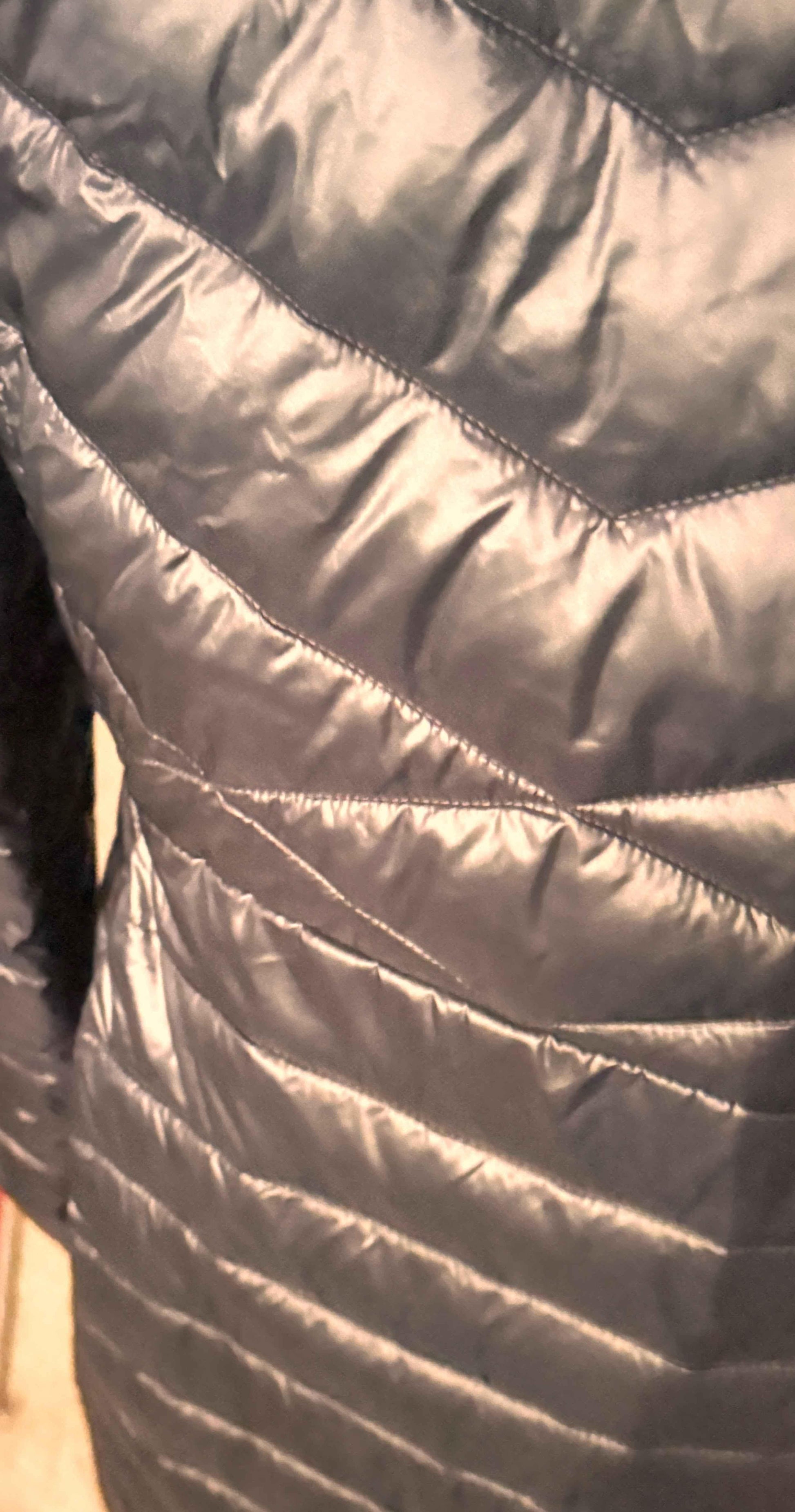 Closeup of black Columbia women's puffer coat with chevron quilted pattern