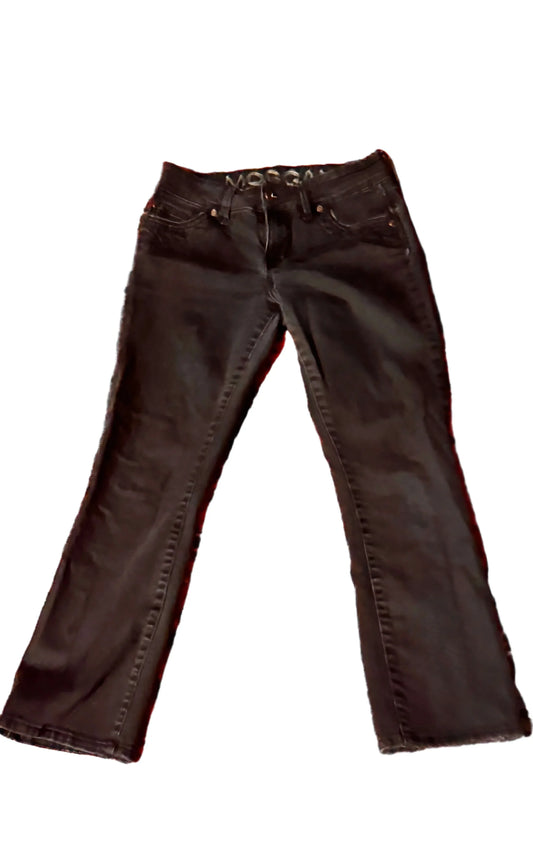 Black denim jeans laid flat on white background, front view, casual fashion pants