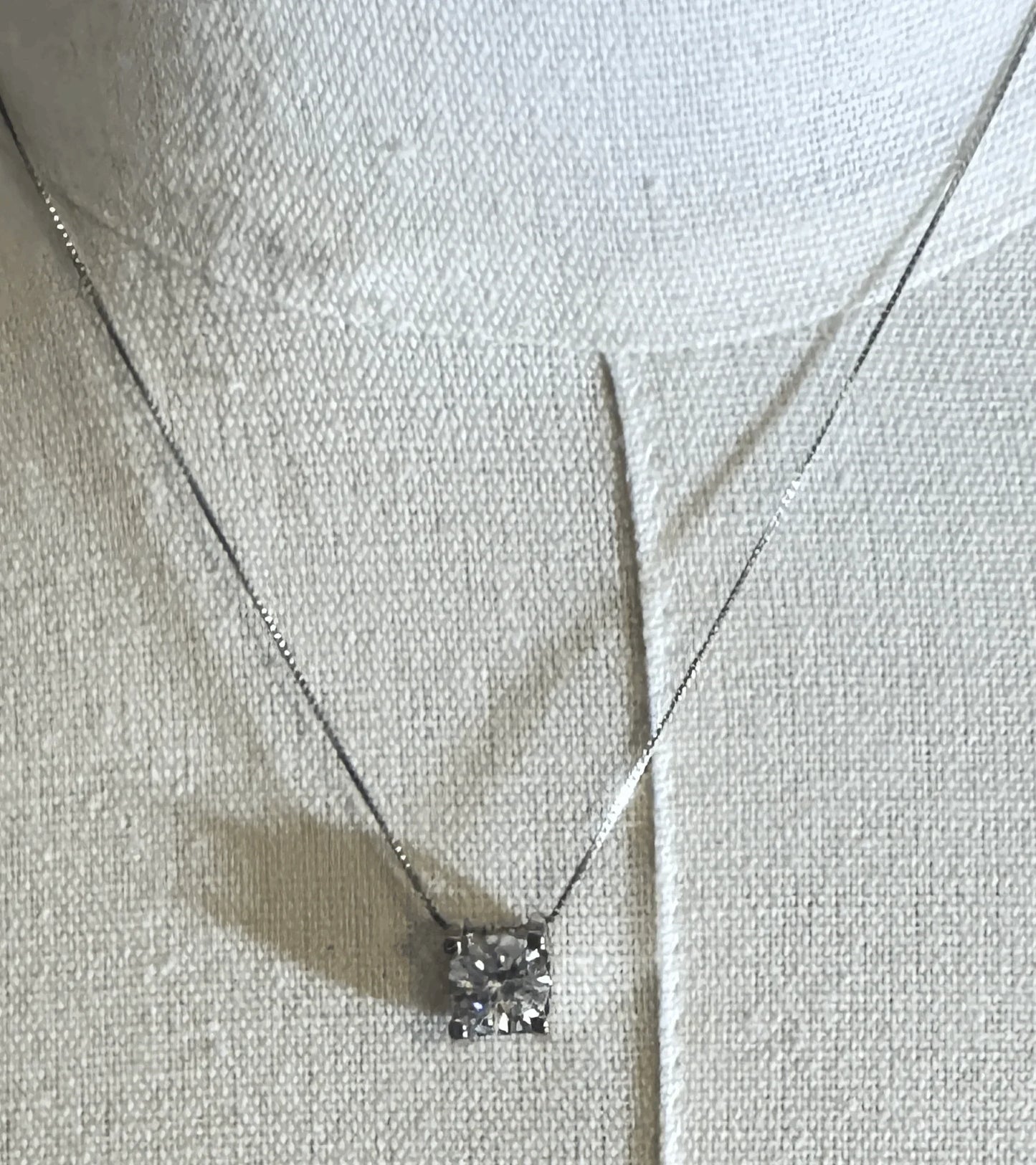 Square diamond pendant necklace on silver chain displayed on fabric bust