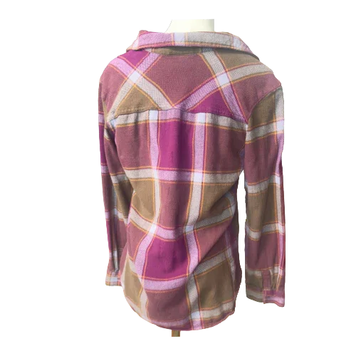 Back view of a pink and tan plaid flannel shirt with pockets on mannequin