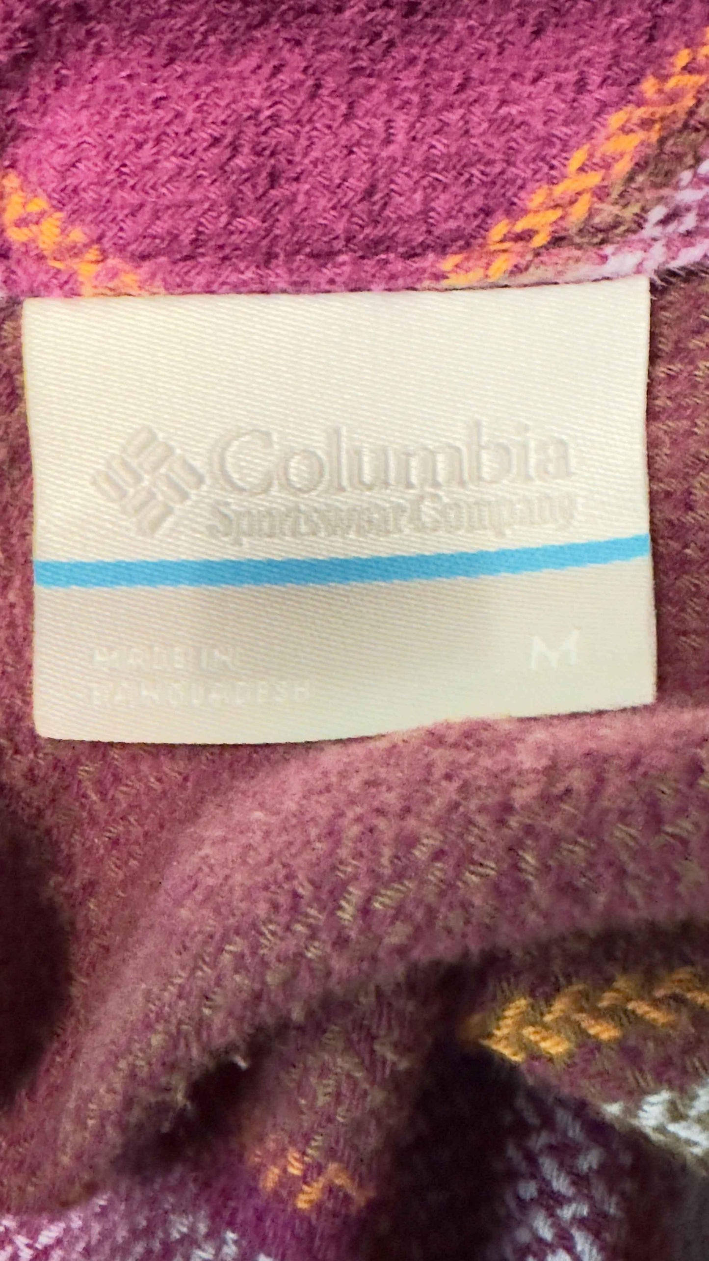Columbia flannel shirt pocket tag on purple plaid fabric, medium size, Bangladesh made