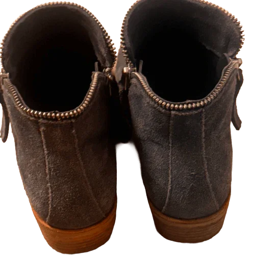 Gray suede ankle boots with zippers, wooden soles, rear view on plain background
