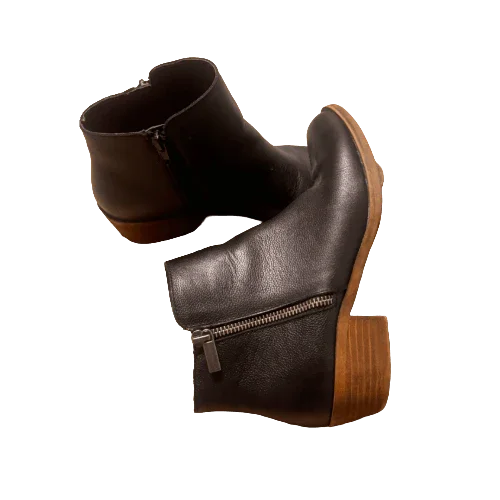 Black ankle boots with side zippers and wooden block heels on white background