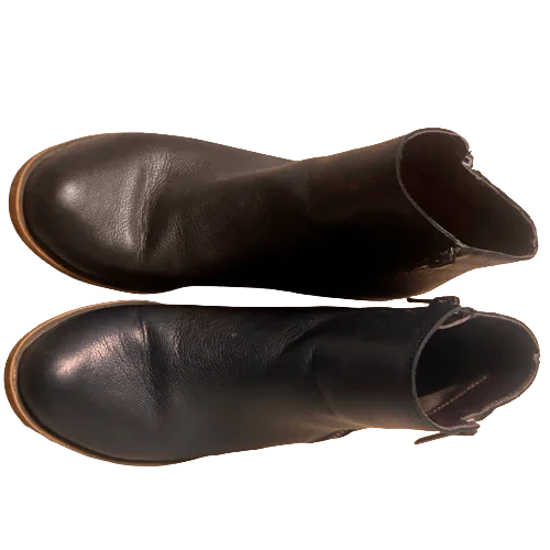 Black leather ankle boots with brown soles on white background