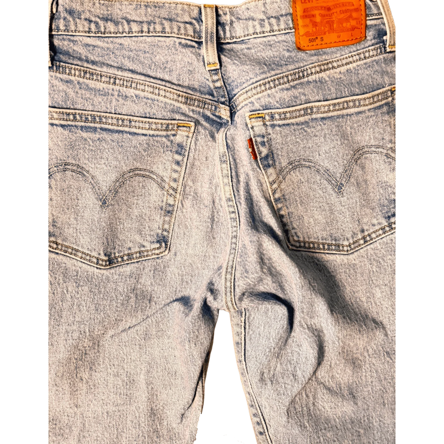 Close-up of Levi's light blue denim jeans back pockets and leather patch