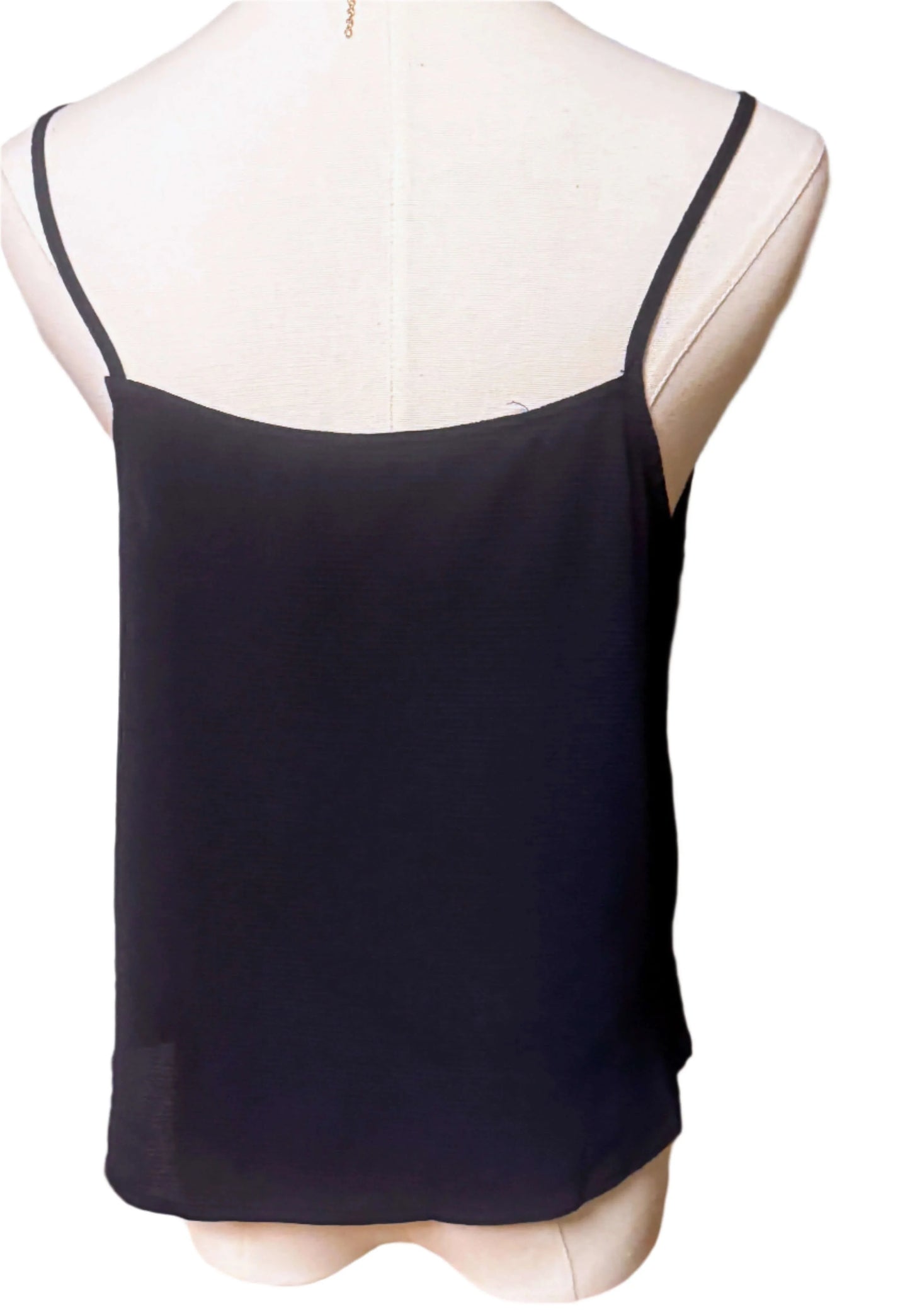 Back view of black sleeveless blouse with spaghetti straps on mannequin