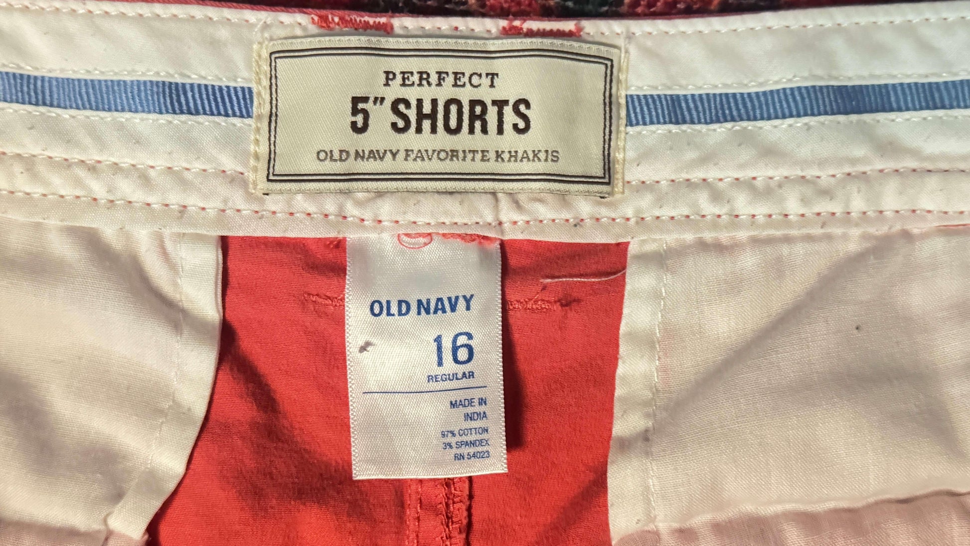 Old Navy favorite khakis 5-inch shorts size 16 label, white and red fabric close-up