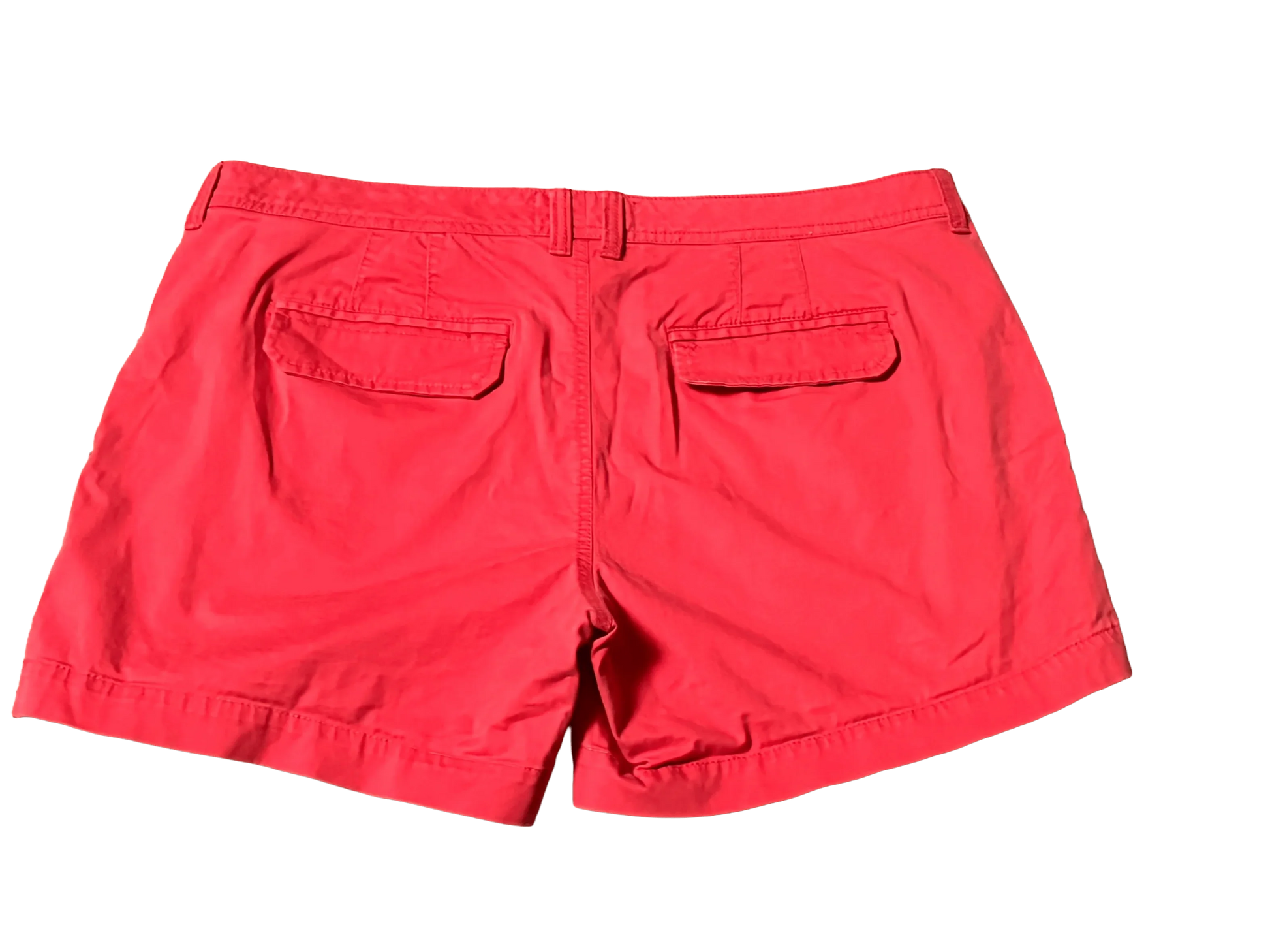 Old Navy red shorts back view with two flap pockets and belt loops on black background