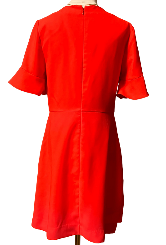 Back view of a bright red Banana Republic dress with short ruffle sleeves on a mannequin